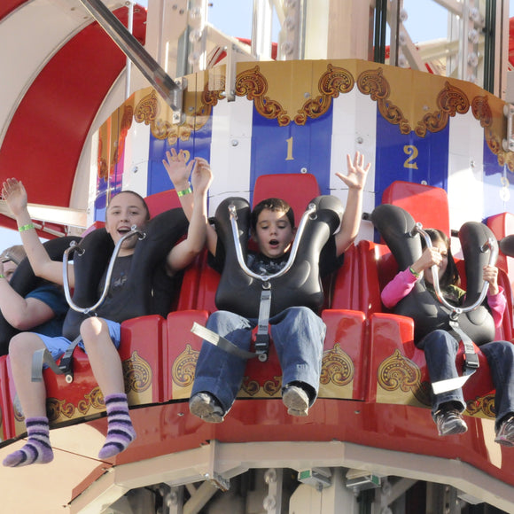 Parachute Drop at ZDT's Amusement Park - Riders holding their hands up at the top of a drop tower that's about to fall.