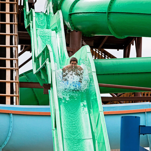 Viper's Tail at ZDT's Amusement Park - Boy racing down on a mat racer slide.