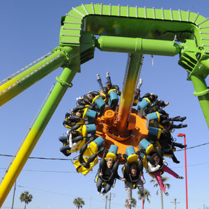 Dizzy Toucan at ZDT's Amusement Park - Riders swinging on a spinning pendulum ride.